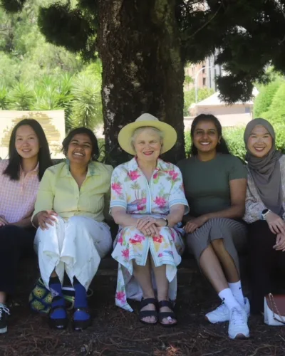 Her Excellency sitting with students at Lunch on the Lawns